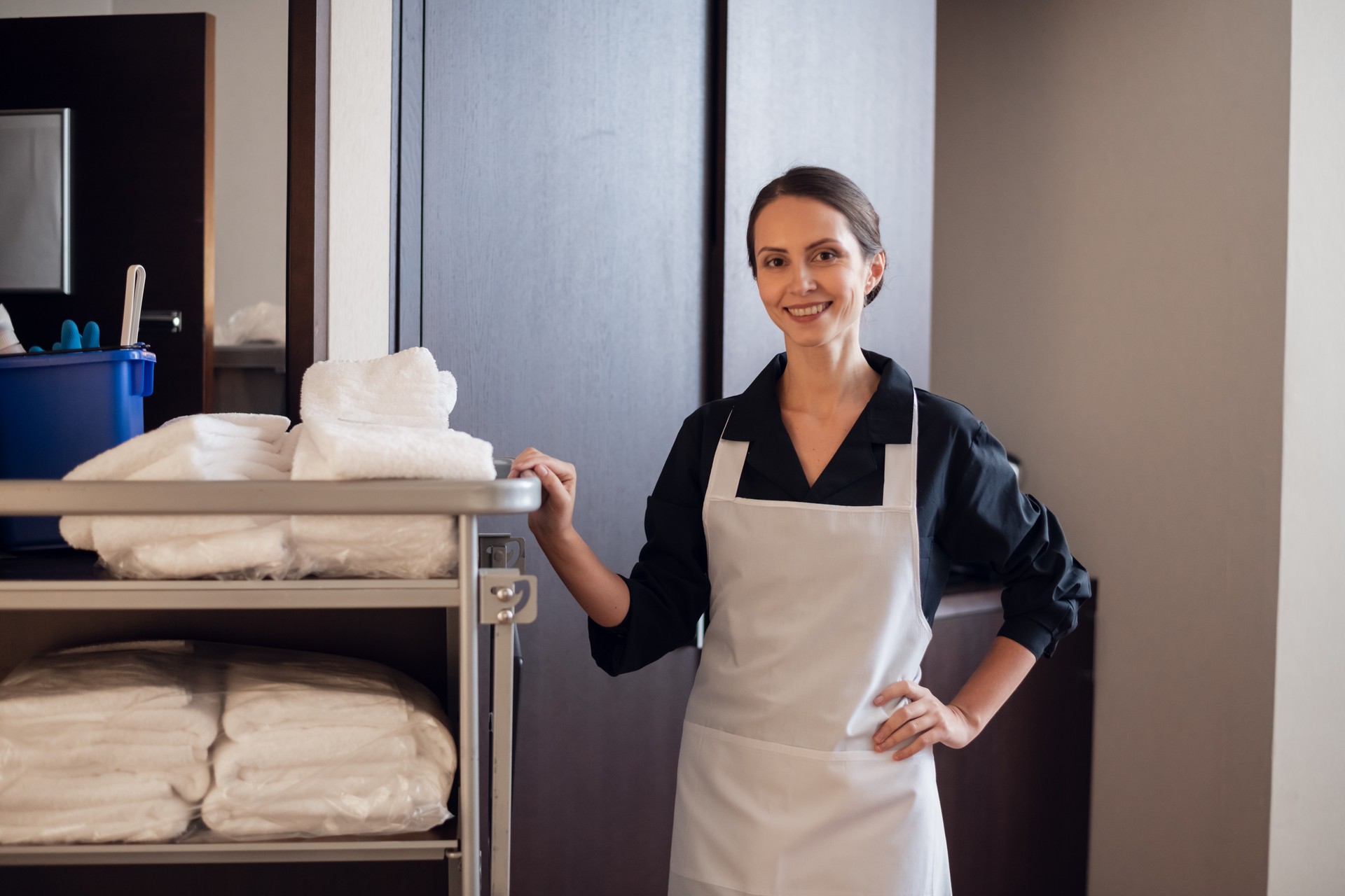 A member of a hotel service staff doing her job